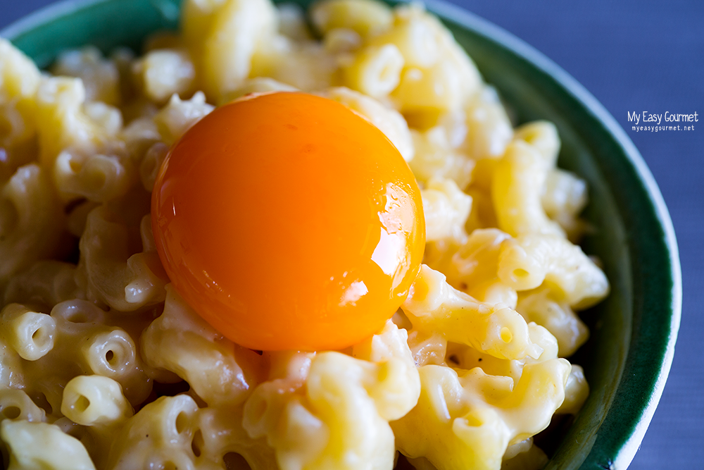 Easy stove-top mac and cheese recipe served with a sous vide egg yolk